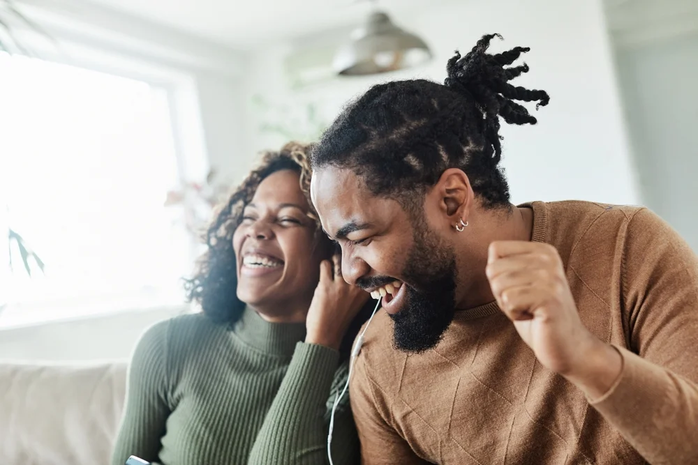 couple sharing earbuds