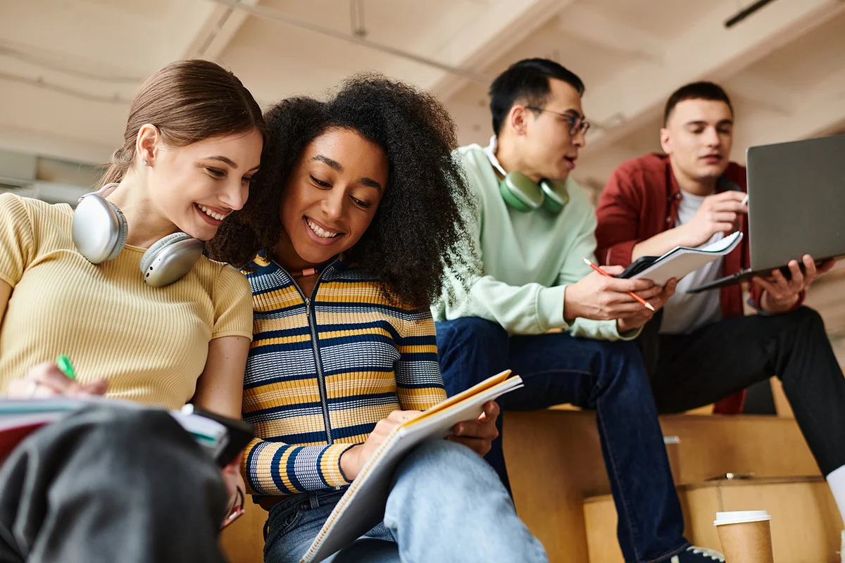 A multicultural group of students engaging in an educational discussion at a university.