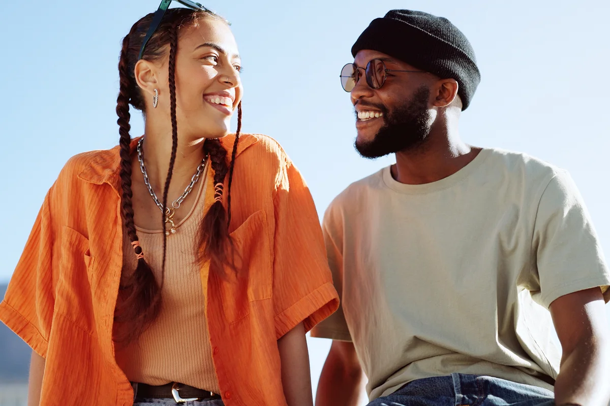 Peace, love and couple in the city to relax, smile and be happy together in summer.