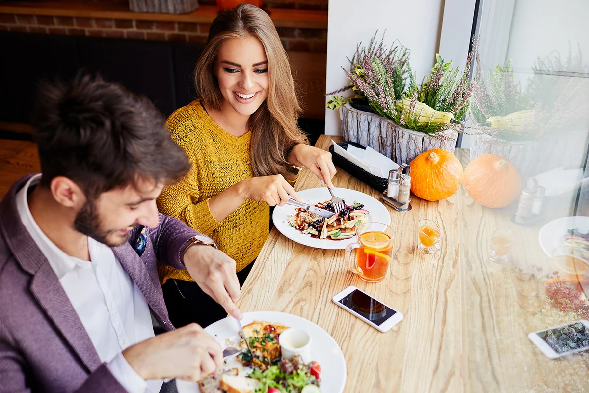 Couple smiling and talking while eating brunch
