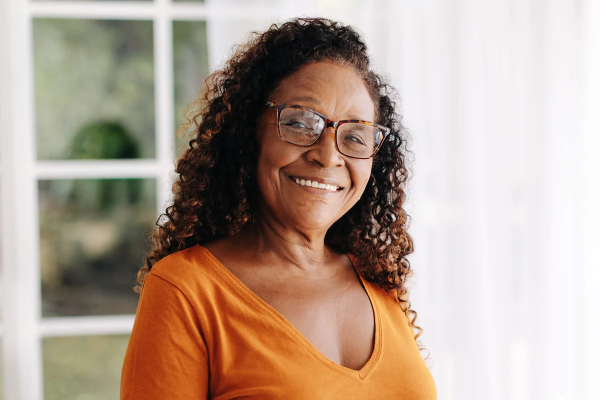 Senior woman living alone uses her smartphone to stay connected and feel secure,