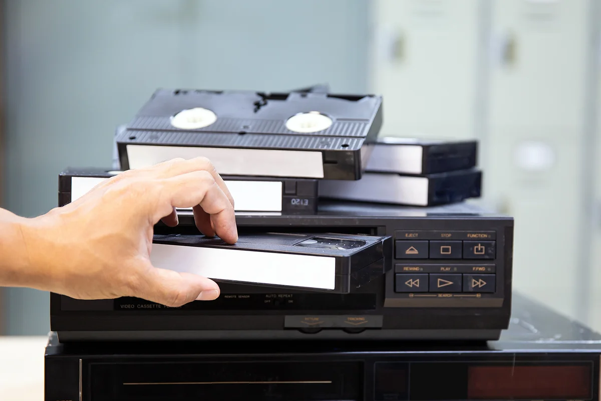 Close-up hand putt playback button on video record player