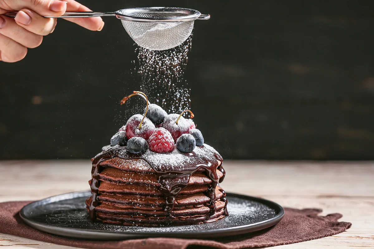 Decorating of delicious chocolate pancakes