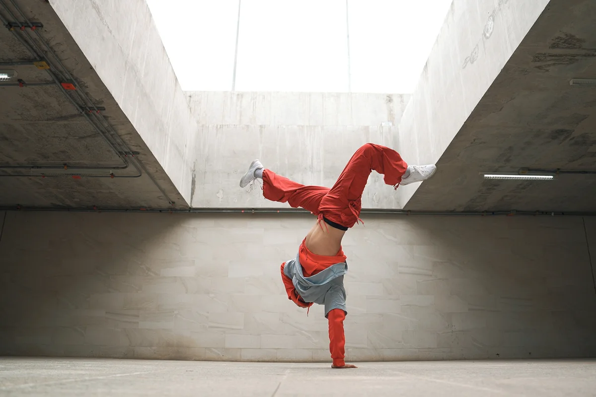 Happy dancing man enjoy practice break dance or freestyle dance in building.
