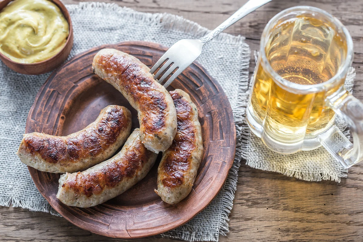 Grilled sausages with fried bacon rashers