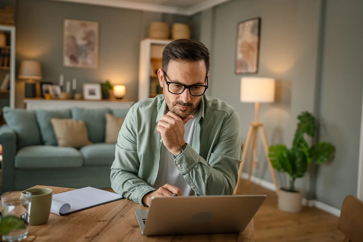 man work on his laptop computer at home
