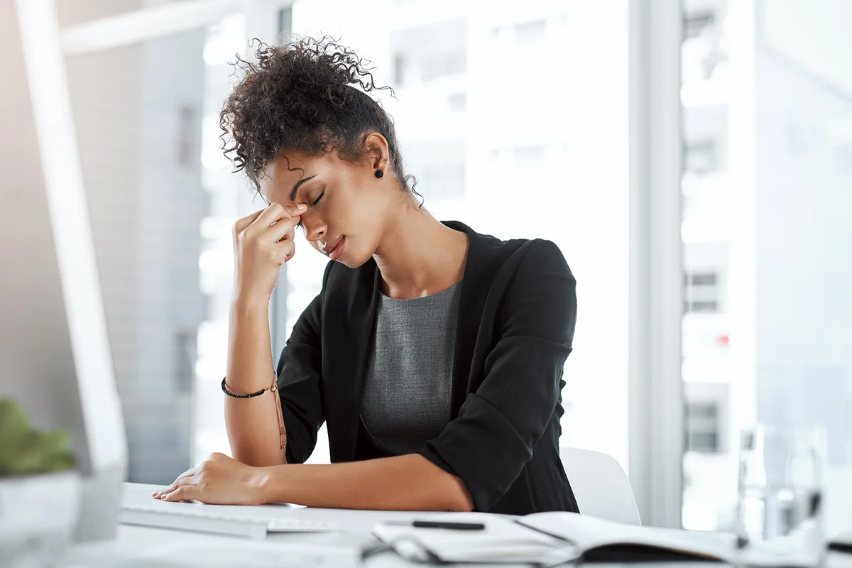 Business, black woman and tired with headache in office from migraine, overworked and stress