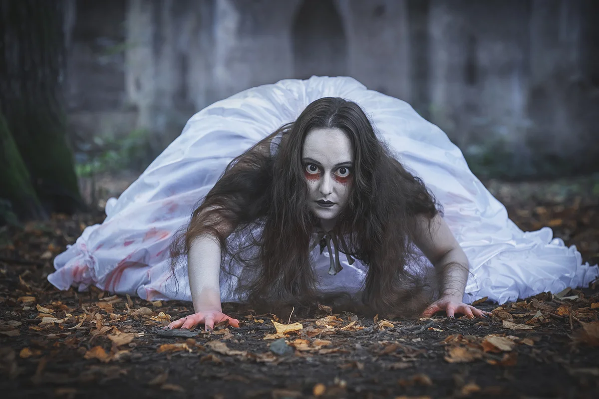 Creepy dead bride crawling from abandoned castle