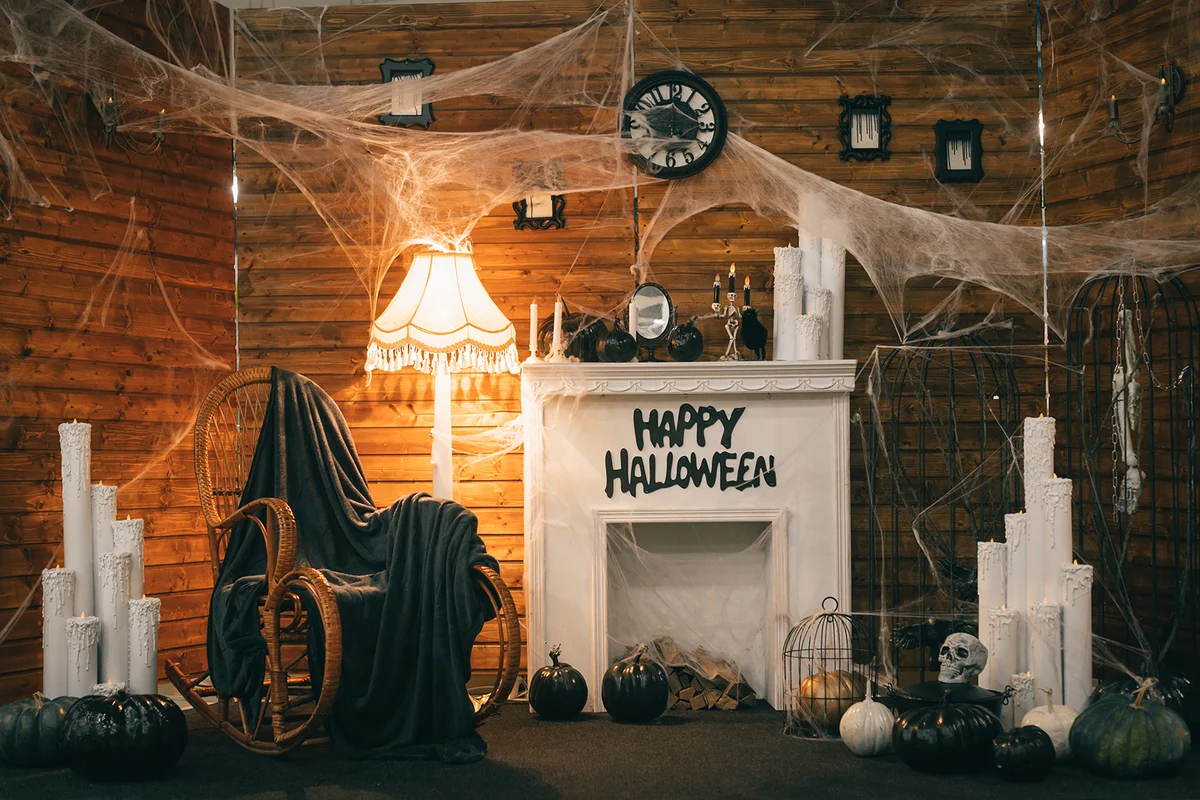 Cozy Halloween decorations with a fireplace and festive attributes.