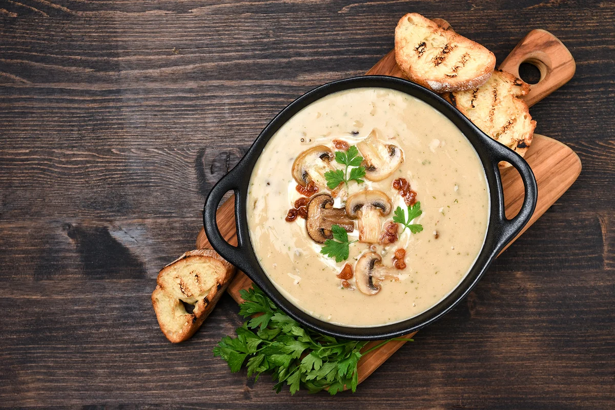 Mushroom champignon soup with bread and fresh mushrooms