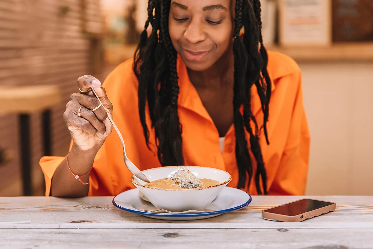 woman eating a healthy vegetable soup