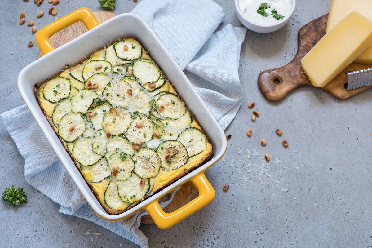 Zucchini casserole with cheese in baking dish