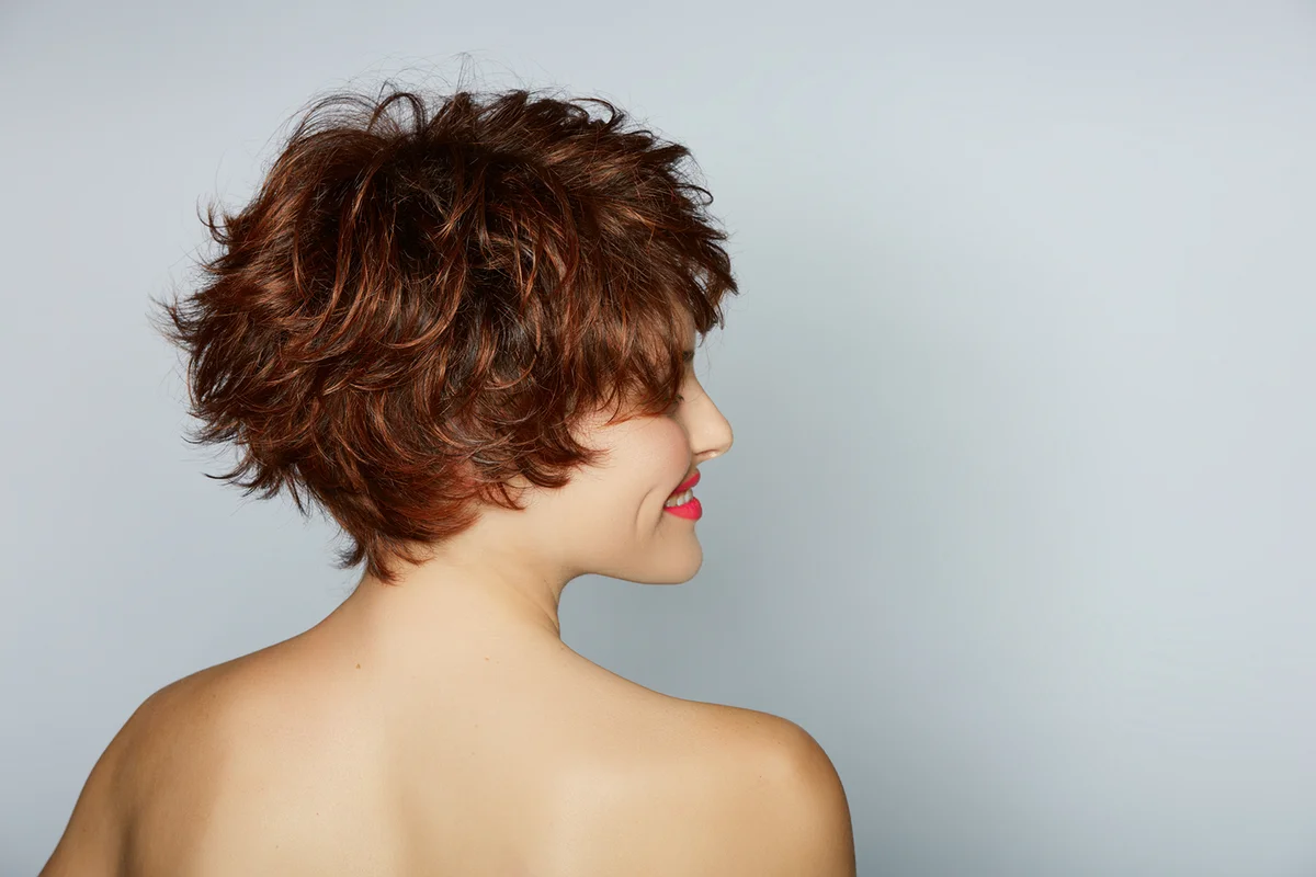 beautiful young woman with red hair wearing short pixie