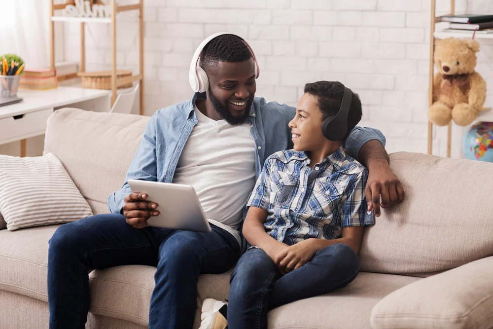 man and boy listening to music