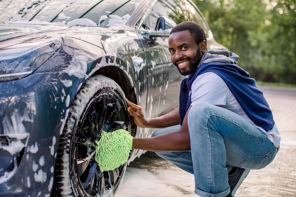 man washing car