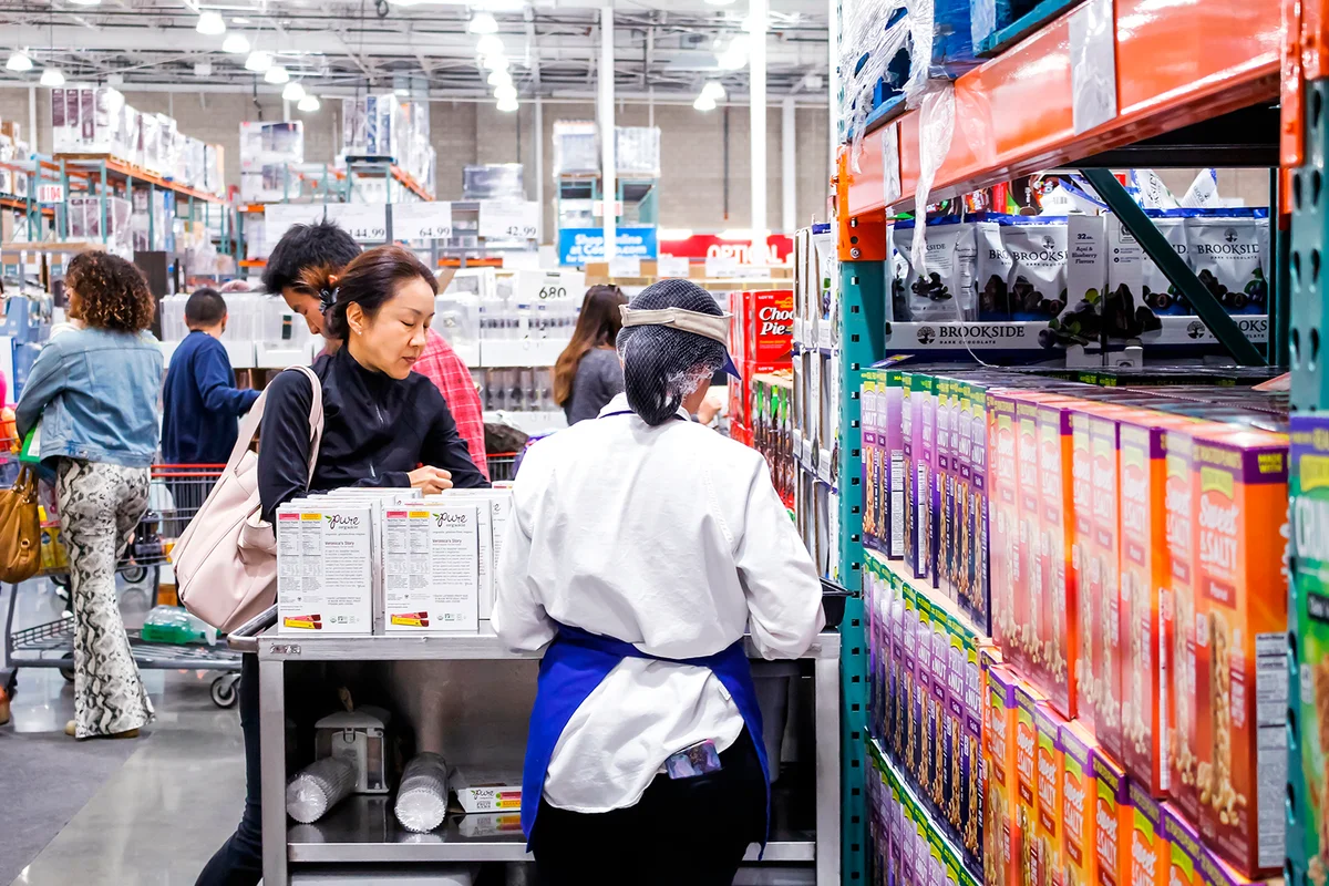 Los Angeles, California, United States - 02-08-2020: A view of the back of a female employee offering samples at a local Costco.