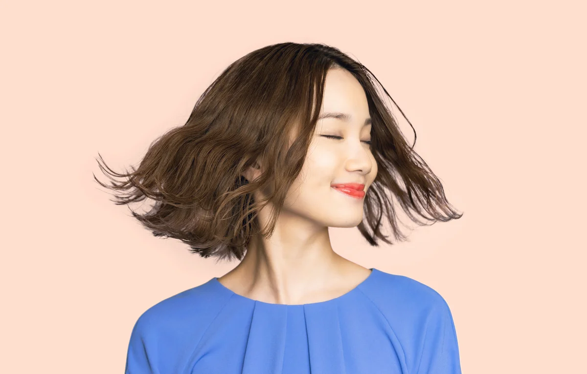 Beauty concept of a young asian woman. Hair care. Cosmetics.