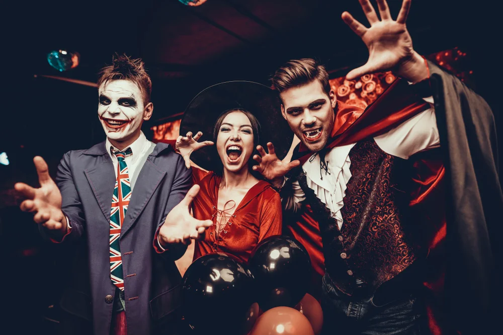 A young group of people in costumes celebrating Halloween.
