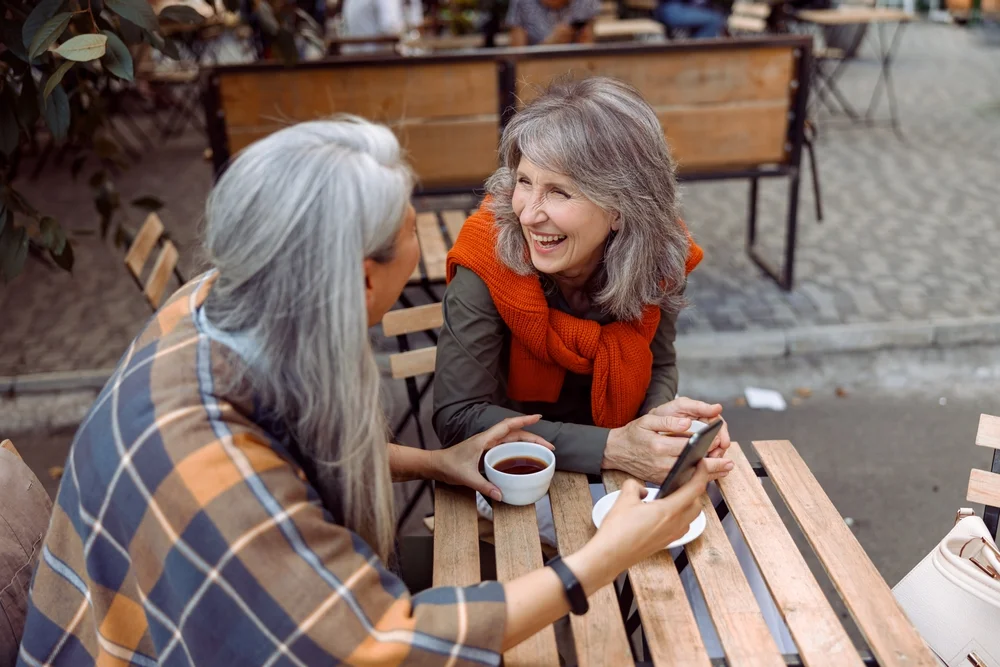 Two ladies socializing and having a fun chat