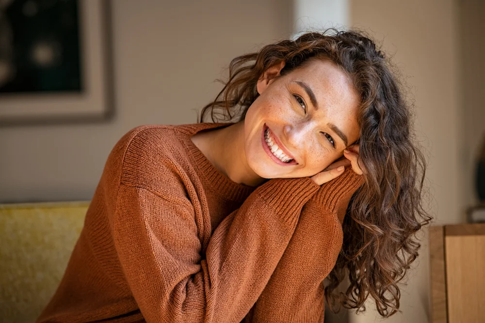 Candid portrait of a young woman smiling.