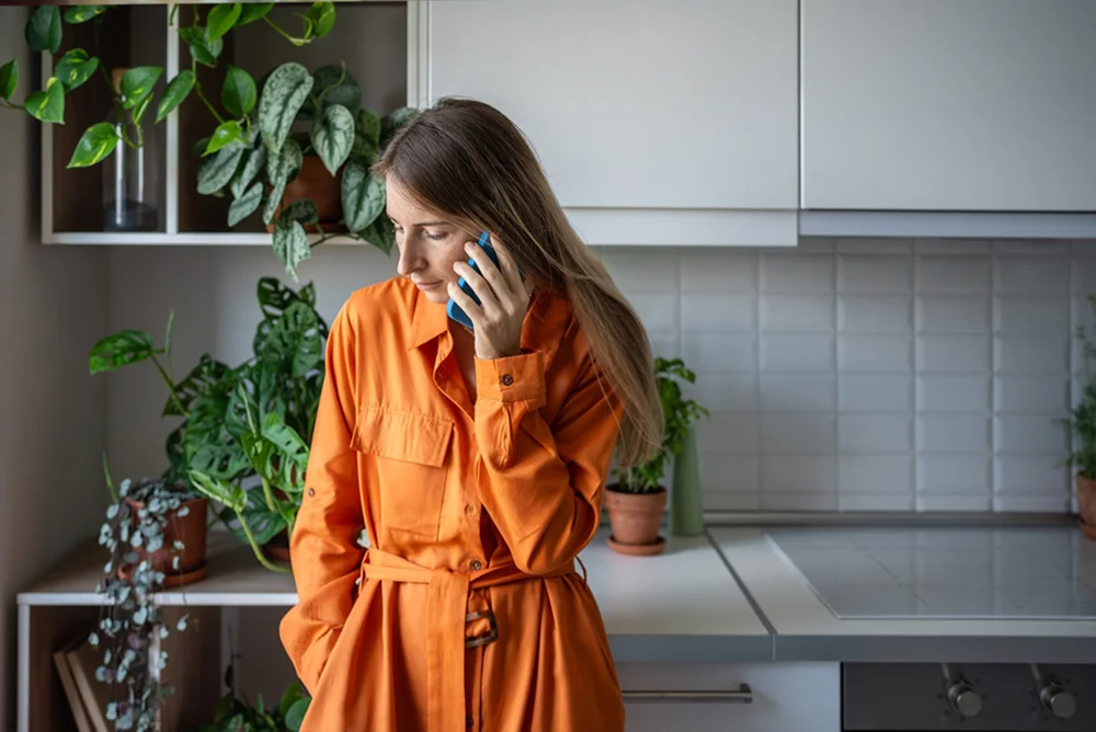 Worried-looking woman trying to make an important phone call.