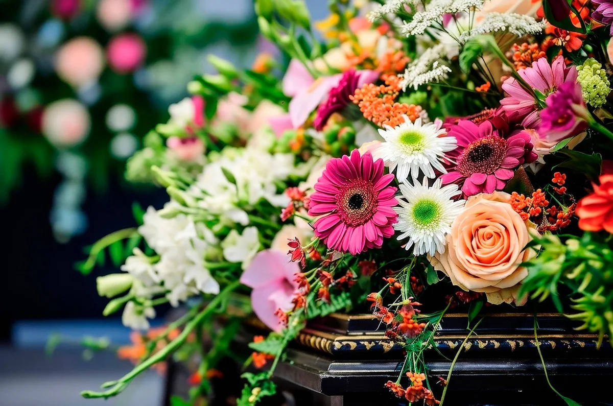 A flower arrangement on a coffin at a funeral