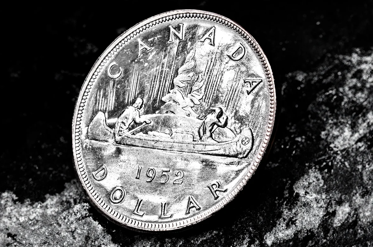 Canadian silver coin background and the effects of environmental damage from years in circulation.