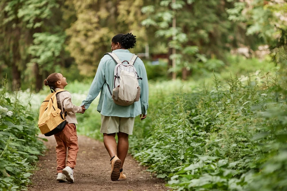 mother and daughter walking in the woods