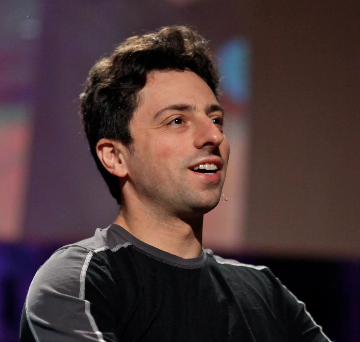 Portrait of Sergey Brin speaking at a conference.