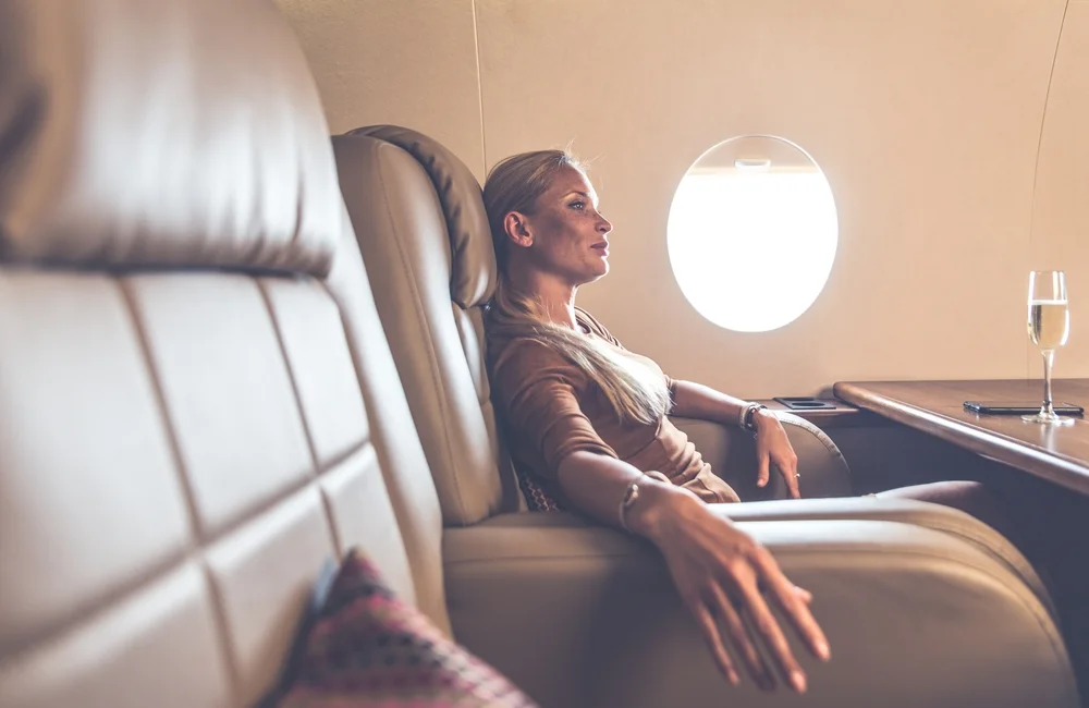 Relaxed woman traveling on her jet.