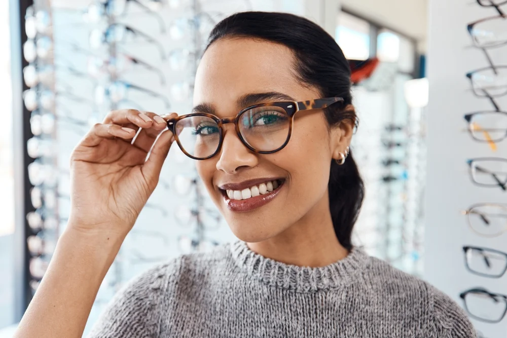 woman trying on glasses frames