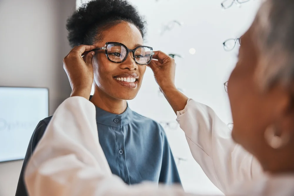 Optician adjusting eyeglasses