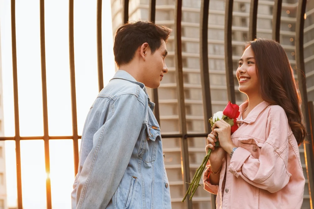 man giving woman flowers