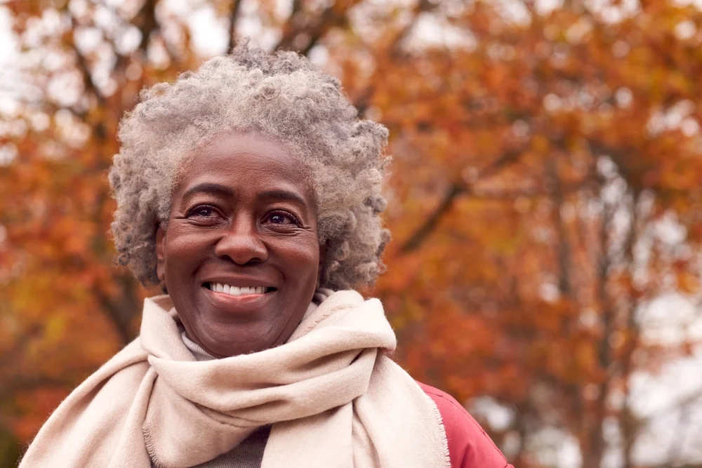 woman with gray hair on a fall day