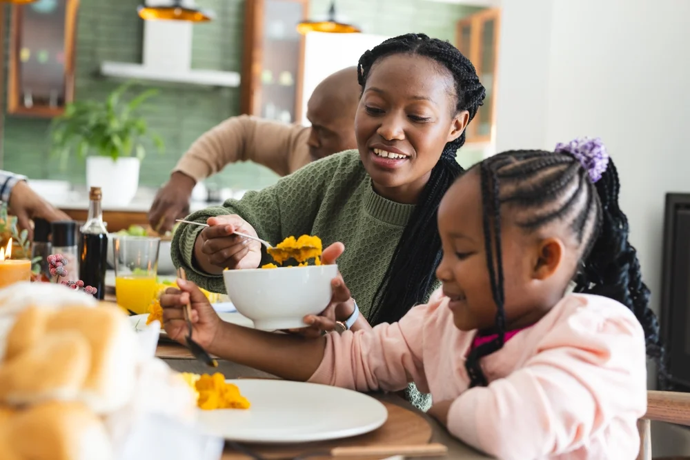 Girl being served food at Thanksgiving