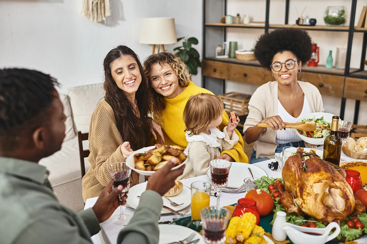 family sharing meal while celebrating Thanksgiving together