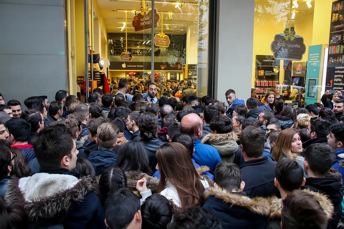 People wait outside a department store during Black Friday shopping deals