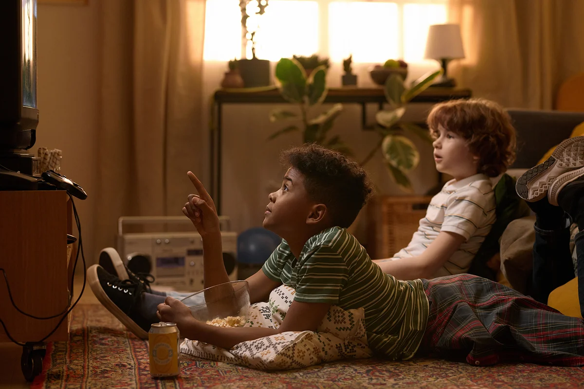 schoolkids lying on floor while watching exciting movie