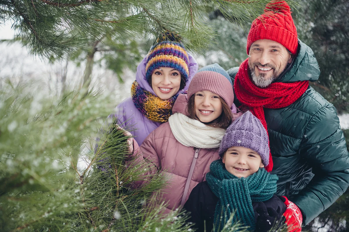 family embrace free time walk snowy cold weather woods outdoors