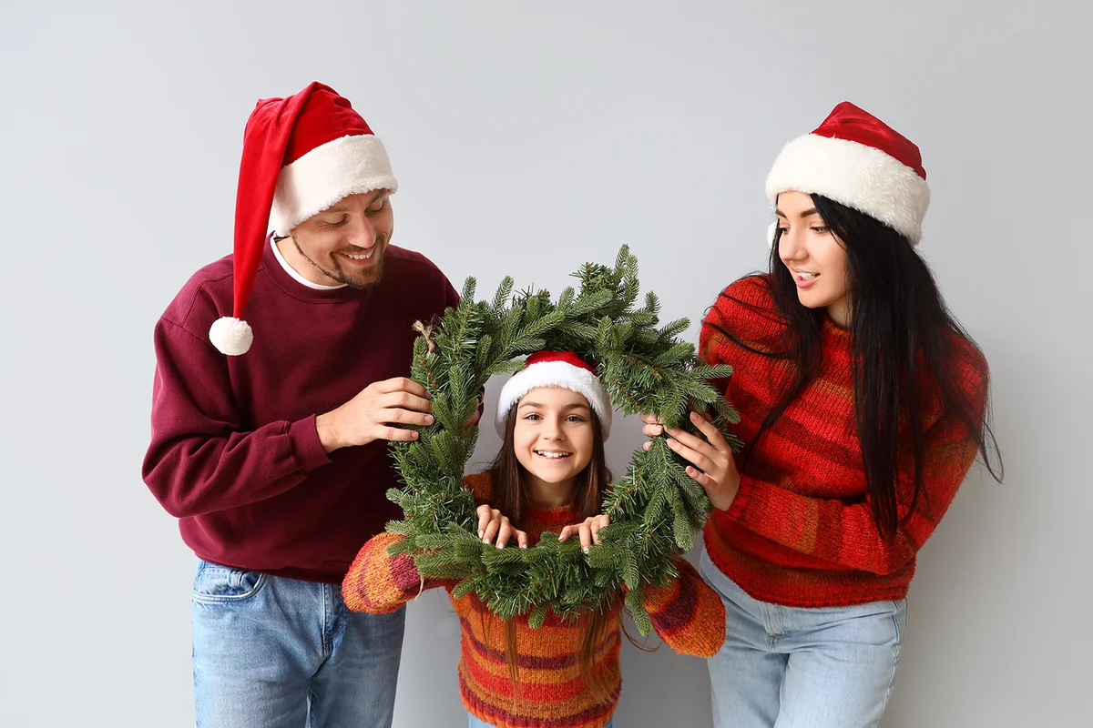Happy family with Christmas wreath