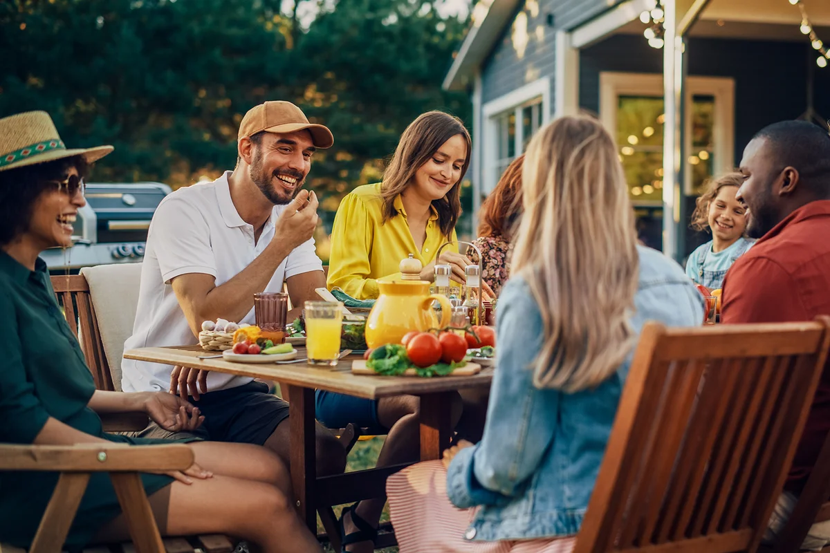 Family and Friends Gathering Together at a Garden Table