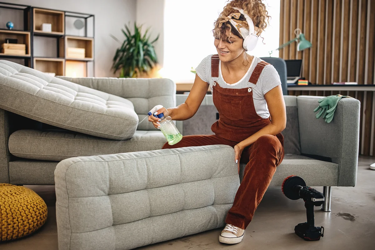 Woman cleaning couch