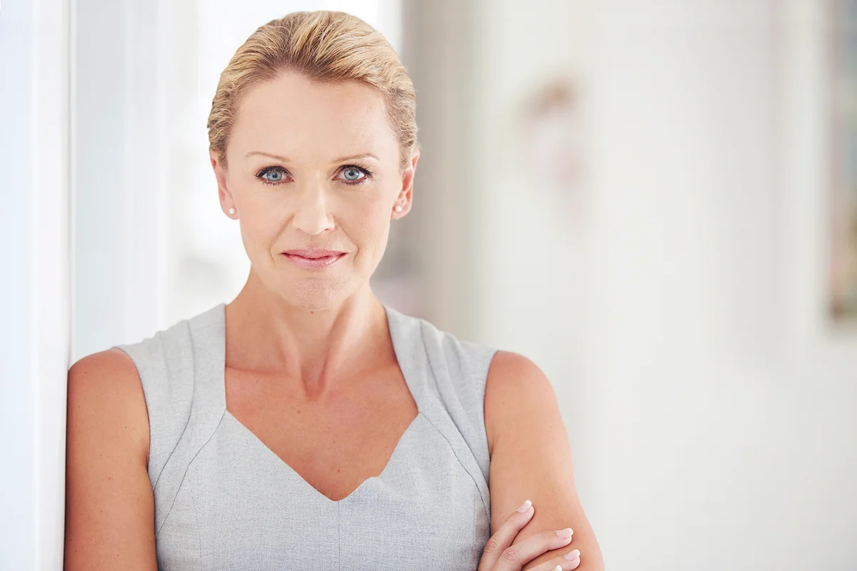 Arms crossed, portrait and serious with business woman in office for administration or management. Corporate, face and mission with confident mature employee in professional workplace for career