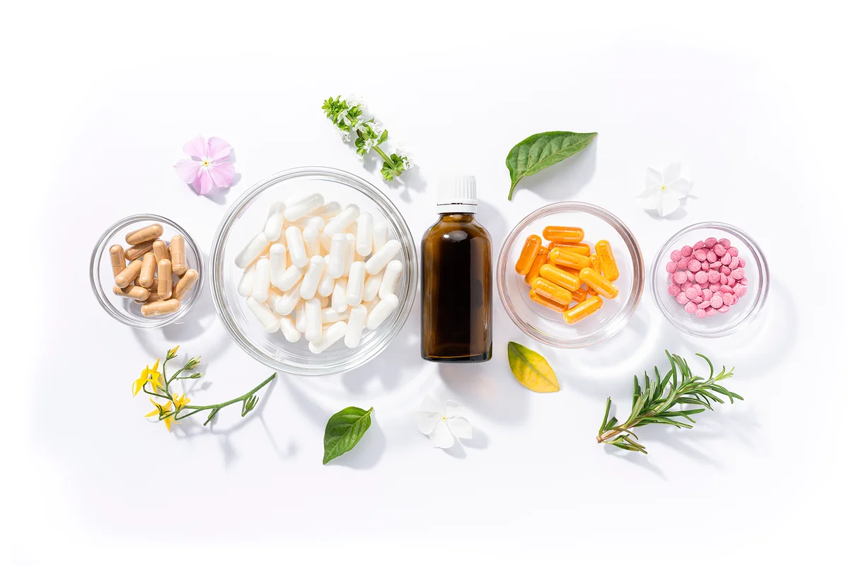 Flat lay composition of various vitamin capsules and dietary supplements isolated on white background. Vitamin complexes concept.