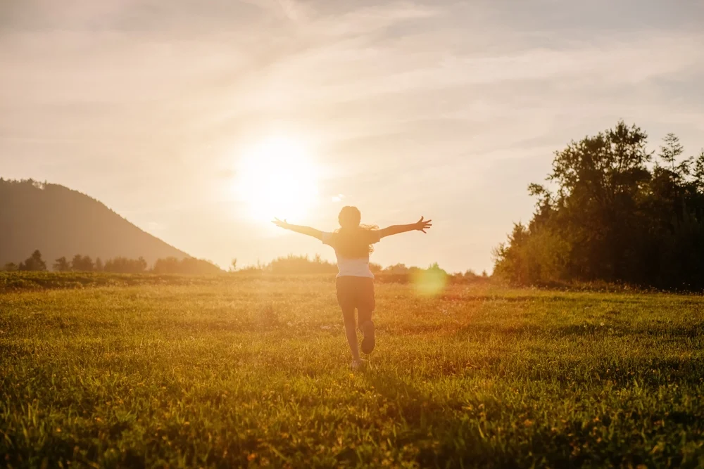 happy person running through a field