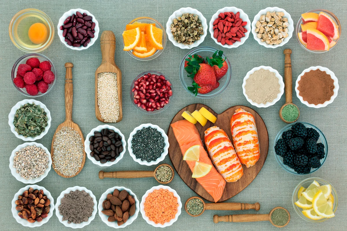 Healthy diet food concept with fresh seafood, fruit, vegetables, pulses, nuts, seeds, grains, dairy, cereals, coffee, nutritional supplement powders and herbs used appetite suppressants