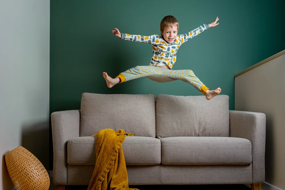 kid jumping on couch