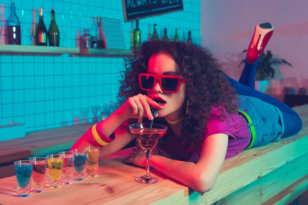 woman in 80s gear on a bar