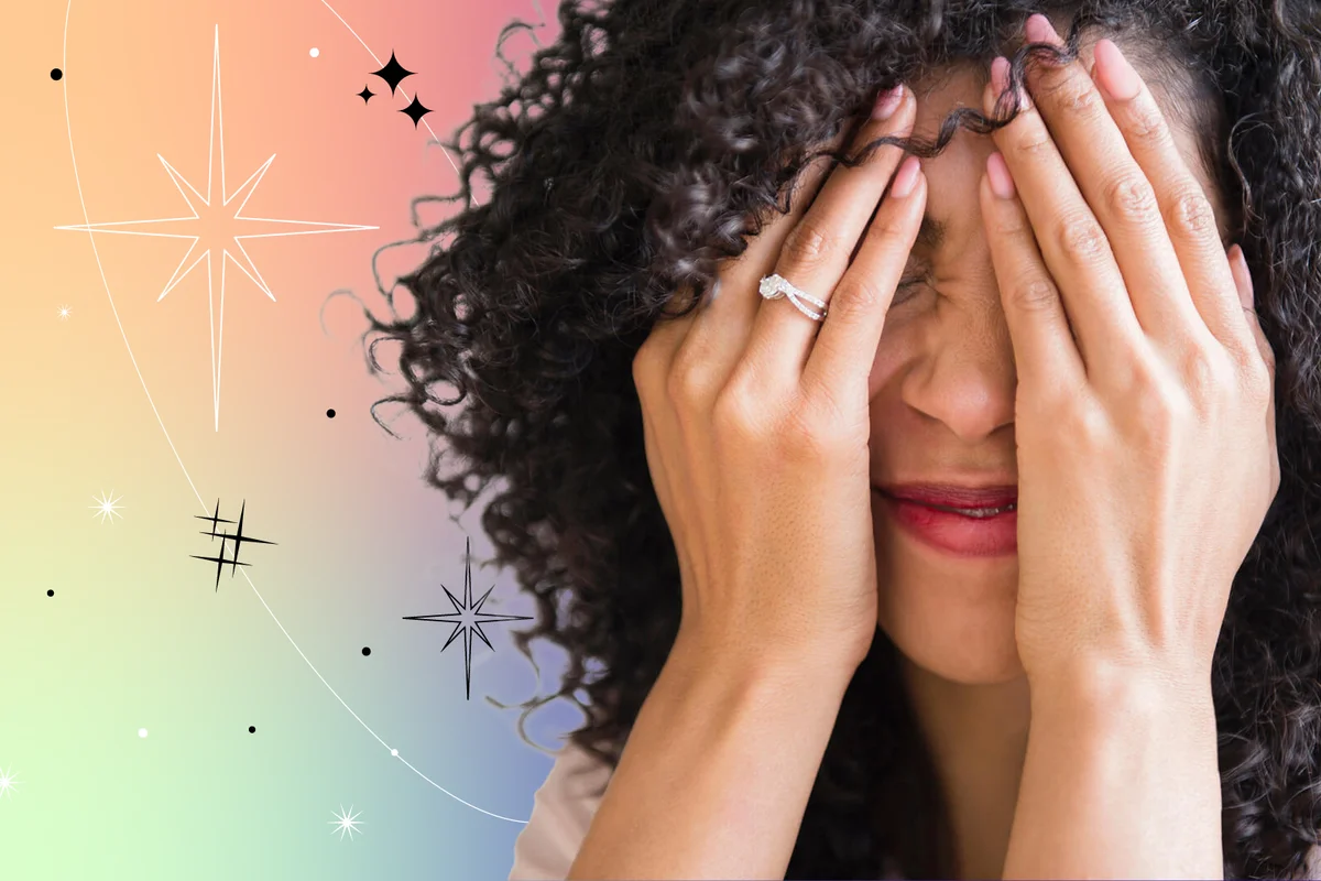 woman with curly hair covering her face