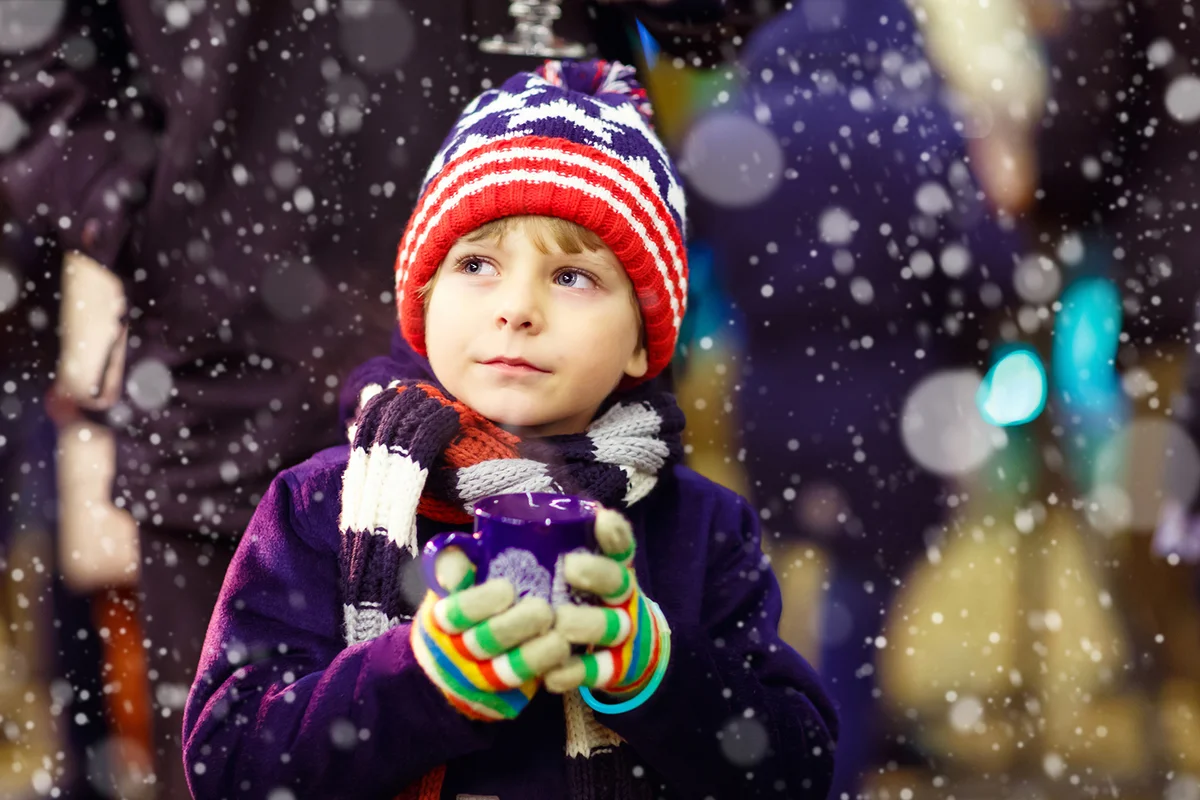 Little cute kid boy with cup of steaming hot chocolate